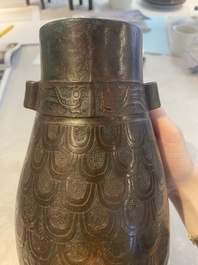 A Chinese archaic bronze inscribed wine vessel with scale design, 'hu 壺', Zhou