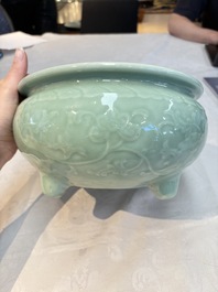 A Chinese celadon-glazed tripod censer with floral anhua design, 18/19th C.