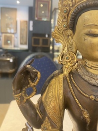 A Tibetan or Nepalese turquoise-inlaid partly-gilt bronze figure of White Tara, 20th C.