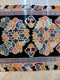 Two Tibetan woollen rugs with floral design, 19th C.