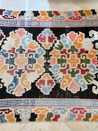 Two Tibetan woollen rugs with floral design, 19th C.