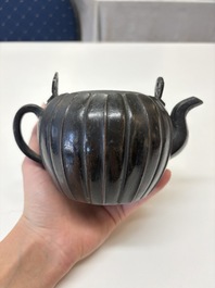 A Chinese bronze teapot and cover with a lion-shaped finial, Yuan