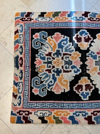 Two Tibetan woollen rugs with floral design, 19th C.