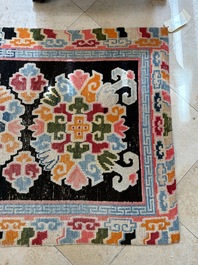 Two Tibetan woollen rugs with floral design, 19th C.
