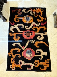 Two Tibetan woollen rugs with floral design, 19th C.