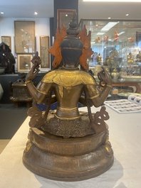 A Tibetan or Nepalese turquoise-inlaid partly-gilt bronze figure of White Tara, 20th C.