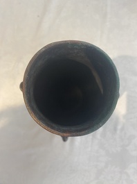 A Chinese archaic bronze inscribed wine vessel with scale design, 'hu 壺', Zhou