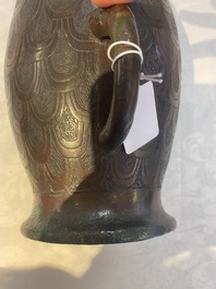 A Chinese archaic bronze inscribed wine vessel with scale design, 'hu 壺', Zhou