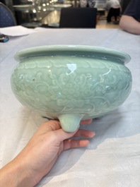 A Chinese celadon-glazed tripod censer with floral anhua design, 18/19th C.