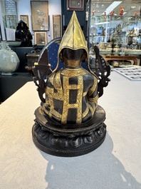 A Tibetan parcel-gilt bronze sculpture of a lama, 20th C.