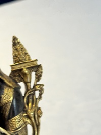 A Tibetan parcel-gilt bronze sculpture of a lama, 20th C.