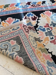 Two Tibetan woollen rugs with floral design, 19th C.