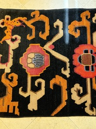 Two Tibetan woollen rugs with floral design, 19th C.