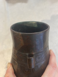 A Chinese archaic bronze inscribed wine vessel with scale design, 'hu 壺', Zhou
