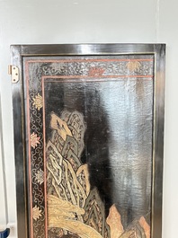 A Chinese Coromandel lacquered four-panel folding screen with mountainous landscapes, 17/18th C.