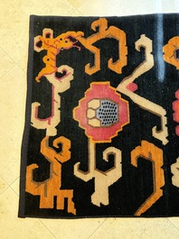 Two Tibetan woollen rugs with floral design, 19th C.
