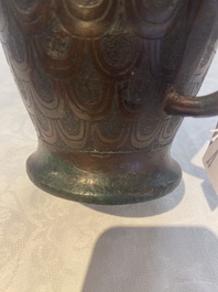 A Chinese archaic bronze inscribed wine vessel with scale design, 'hu 壺', Zhou