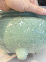 A Chinese celadon-glazed tripod censer with floral anhua design, 18/19th C.