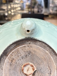 A Chinese celadon-glazed tripod censer with floral anhua design, 18/19th C.