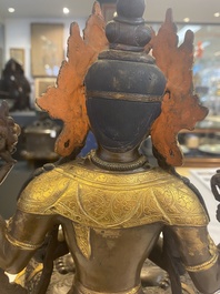 A Tibetan or Nepalese turquoise-inlaid partly-gilt bronze figure of White Tara, 20th C.