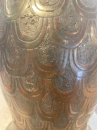 A Chinese archaic bronze inscribed wine vessel with scale design, 'hu 壺', Zhou