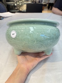 A Chinese celadon-glazed tripod censer with floral anhua design, 18/19th C.