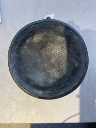 A Chinese archaic bronze inscribed wine vessel with scale design, 'hu 壺', Zhou