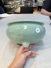 A Chinese celadon-glazed tripod censer with floral anhua design, 18/19th C.
