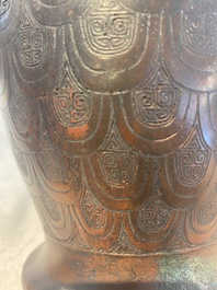 A Chinese archaic bronze inscribed wine vessel with scale design, 'hu 壺', Zhou