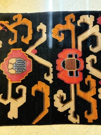 Two Tibetan woollen rugs with floral design, 19th C.