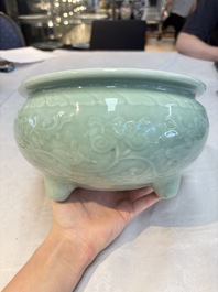 A Chinese celadon-glazed tripod censer with floral anhua design, 18/19th C.