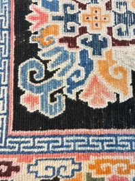 Two Tibetan woollen rugs with floral design, 19th C.