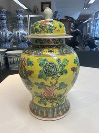 A pair of Chinese famille verte yellow-ground 'pheasants and peonies' vases and covers, 19th C.