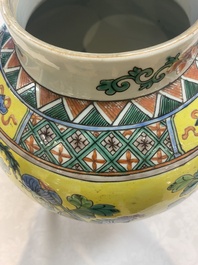 A pair of Chinese famille verte yellow-ground 'pheasants and peonies' vases and covers, 19th C.