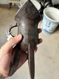 A Chinese archaic bronze wine vessel with taotie design, 'jue 爵', Zhou
