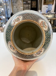 A Chinese famille verte 'phoenixes' vase and cover, 19th C.
