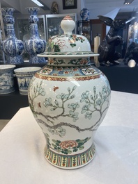 Two Chinese famille verte 'birds and flowers' vases and covers, 19th C.