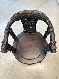 A pair of Chinese finely carved hongmu swivel chairs, Canton, 19th C.