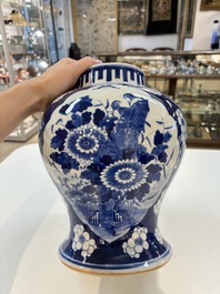 A pair of Chinese blue and white covered vases with floral design, 19th C.