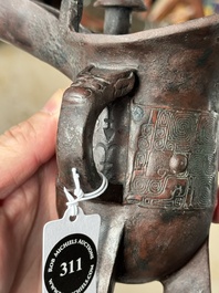 A Chinese archaic bronze wine vessel with taotie design, 'jue 爵', Zhou