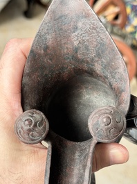 A Chinese archaic bronze wine vessel with taotie design, 'jue 爵', Zhou
