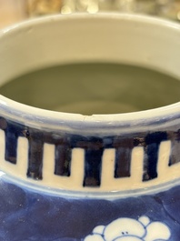 A pair of Chinese blue and white covered vases with floral design, 19th C.