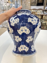 A pair of Chinese blue and white covered vases with floral design, 19th C.