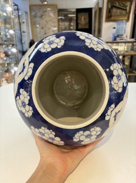 A pair of Chinese blue and white covered vases with floral design, 19th C.