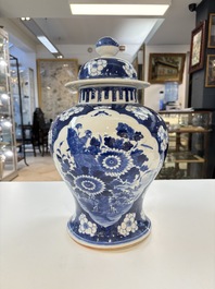 A pair of Chinese blue and white covered vases with floral design, 19th C.