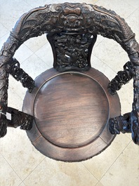 A pair of Chinese finely carved hongmu swivel chairs, Canton, 19th C.