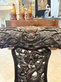 A pair of Chinese finely carved hongmu swivel chairs, Canton, 19th C.