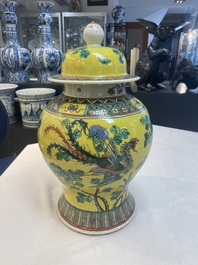 A pair of Chinese famille verte yellow-ground 'pheasants and peonies' vases and covers, 19th C.