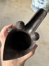 A Chinese archaic bronze wine vessel with taotie design, 'jue 爵', Zhou