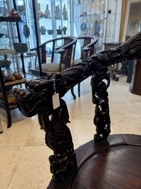 A pair of Chinese finely carved hongmu swivel chairs, Canton, 19th C.